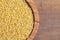 Proso millet on wooden background