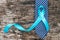 Prostate cancer awareness concept with light blue ribbon on necktie and old aged wood for men\\\'s health care campaign