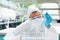 Protected female scientist looking at a test tube