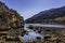 Protected natural harbour as seen behind rocks, shot low, under clear blue skies