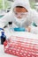 A protected scientist dropping liquid in a tube