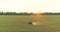 Protecting fields from pests. Large wheat field drone view. A tractor sprays a wheat field, a top view.