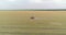 Protecting fields from pests. Large wheat field drone view. A tractor sprays a wheat field, a top view.