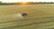 Protecting fields from pests. Large wheat field drone view. A tractor sprays a wheat field, a top view.
