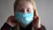 Protection against coronavirus. girl puts a mask on her face.
