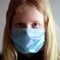 Protection against coronavirus. girl puts a mask on her face.