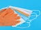 Protection concept - pair of orange latex medical gloves and colored surgical masks on blue background
