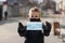 Protection and epidemic concept. Young adult asian girl with covered nose and mouth holding in hands safety face mask