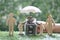 Protection money, Model family and stack of coins money in glass bottle with hand holding the umbrella on green background,