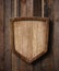 Protection shield shaped sign hanging on ropes with wood planks background