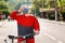 Protection from the virus. Portrait of a woman in a protective medical mask and sportswear, holding a Bicycle, and clutching her