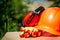 Protective helmet, headphones, gloves, glasses on a wooden table, against the background of nature