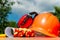 Protective helmet, headphones, gloves on a wooden table, against the background of nature