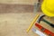 Protective helmet, mason tools on wood background