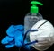 Protective mask , blue latex gloves and transparent plastic botle with antibacterial sanitizer fluid