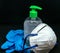 Protective mask , blue latex gloves and transparent plastic botle with antibacterial sanitizer fluid