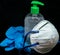 Protective mask , blue latex gloves and transparent  plastic botle with antibacterial sanitizer fluid