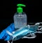 Protective mask , blue latex gloves and transparent white plastic botle with sanitizer fluid
