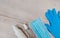 Protective mask, gloves and bactericidal spray on a wooden background