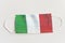 Protective medical mask with Italian flag . Symbol of closing state borders and pandemic control