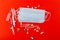 Protective medical mask, syringes, ampoules and medicines on a red background