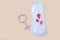 Protective menstrual pad and gender symbol made from pink pain pills. The concept of women gynecological health and intimate