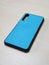 Protective phone case made of dense material with rubber edges. Back wall is plastic with silicone coating, fabric texture, blue