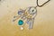 Protective power. Jewelry charm or talisman. Luck amulet on textile background. Name amulet for good luck. Silver amulet with gems