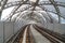 Protective sound barrier wall along elevated train rail line