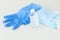 protective stuff, blue medical mask and glove, white bottle of sanitizer on light background.