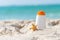 Protective sunscreen or sunblock and sunbath lotion in white plastic bottles with sandals on tropical beach, summer accessories in