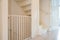 Protective white baby safety stair gate in hallway stairwell modern new house, fence for children in beautiful home