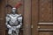 The protector - Armoured medieval knight standing in front of an old door