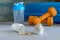 Protein powder in scoop, dumbbell, yoga mat and shaker. Fitness and sport concept