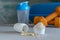 Protein powder in scoop, dumbbell, yoga mat and shaker. Fitness and sport concept