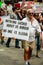 Protest against ICE and Border Patrol Detention Centers. A man carries a sign that reads `Nothing sacred about US border...`