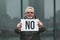 Protest - no! An adult man with a poster in his hands, one activist outside