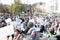 Protest or public demonstration, focus on microphone, blurred crowd of people in the background