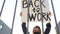 Protest rally near the grate of the municipal government, poster back to work. Participant in a demonstration against