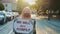 Protest walk: woman in a medical mask holding placard with words that people won`t comply