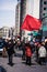 Protester Agitating a Red Flag in the Street