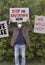 Protester with cap and medical protection mask demonstrate against stay-at-home orders due to the COVID-19 pandemic