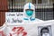 Protester in Hazmat Suit In Solidarity With The Chinese People Holds Down With Xi Jinping Sign