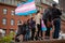 Protester marching for a peace pride rainbow flag at the Boston March for Our Lives political rally