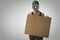 Protester with megaphone and cardboard poster in hands on gray background