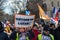 Protester showing a sign reading \\\'Let\\\'s get out of NATO !\\\' during a demonstration in Paris, France