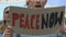Protesters with banners shouting Peace now, anti-war movement, against terrorism
