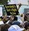 Protesters in Denver Colorado Carry Signs Critical of ICE, Immigration Police and an Immigration Detention Facility.