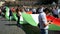 protesters hold up a huge tricolor marching from Piazza del Popolo to Piazza Venezia