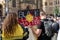 Protestor holding a `Black Lives Matter` placard in the Aboriginal flag background